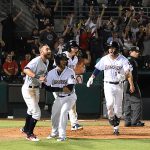 The Missions celebrate at the plate after Jake Hager scored the winning run in the ninth inning in the Missions' 6-5 victory over the Redbirds on Tuesday at Wolff Stadium. - photo by Joe Alexander