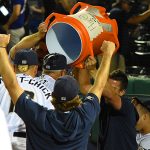Missions players dump ice-water on manager Rick Sweet in the dugout after Tuesday's victory gave him 2,000 for his career. - photo by Joe Alexander