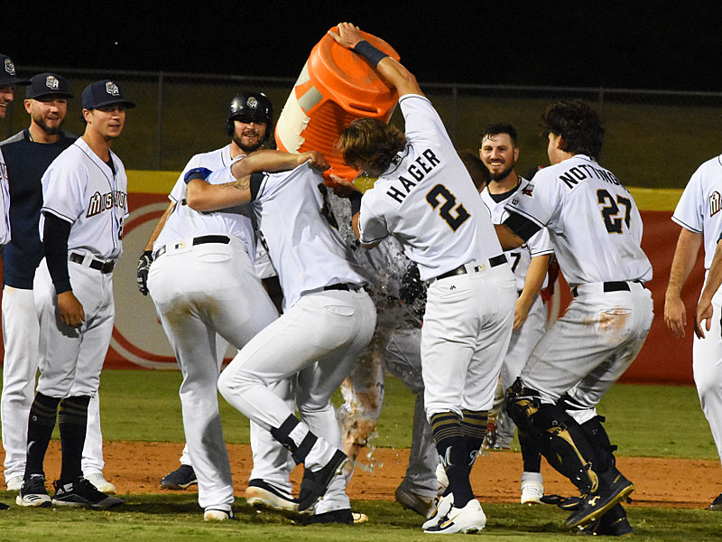 The Missions celebrate after Hernan Perez's walk-off hit in the 12th inning Saturday night at Wolff Stadium. - photo by Joe Alexander