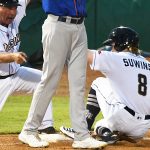 The San Antonio Missions' Jack Suwinski slides into third with a triple in front of Missions manager Phillip Wellman. The Missions beat the Midland RockHounds 4-2 Tuesday night at Wolff Stadium. - photo by Joe Alexander