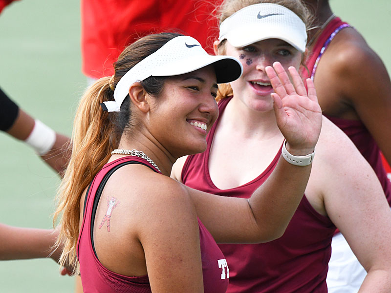 Megan Flores waves to the stands after winning her doubles match on Trinity tennis senior day on Friday, April 15, 2022. - photo by Joe Alexander