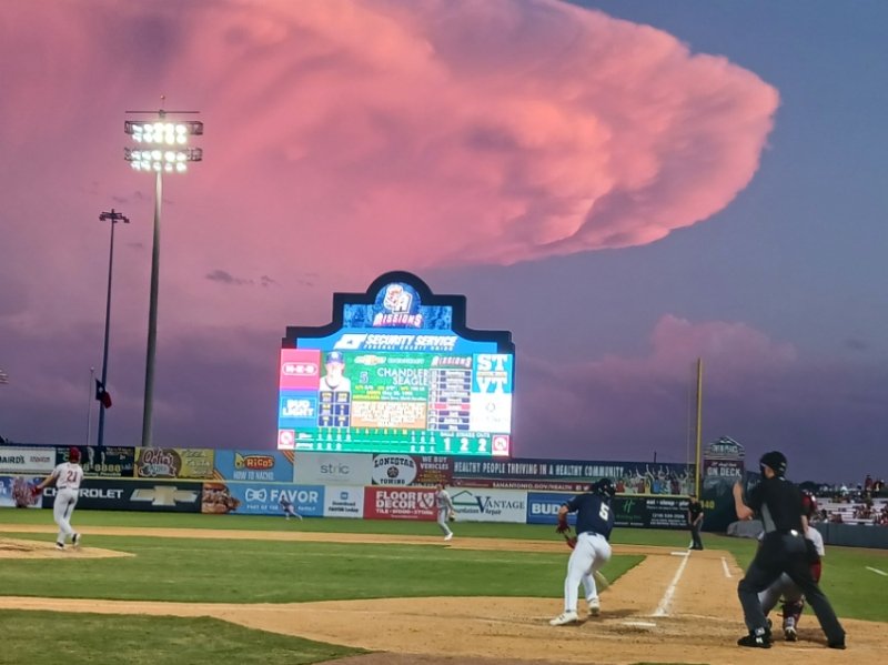 The San Antonio Missions' Chandler Seagle doubles in the fourth inning just after sunset as a thundercloud passes in the distance south of Wolff Stadium on Saturday, April 15, 2023. - photo by Joe Alexander