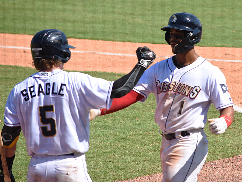 Chandler Seagle congratulates Ray-Patrick Didder after Didder's ninth-inning home run. The Wichita Wind Surge beat the San Antonio Missions 8-7 on Sunday, June 11, 2023, at Wolff Stadium. - photo by Joe Alexander
