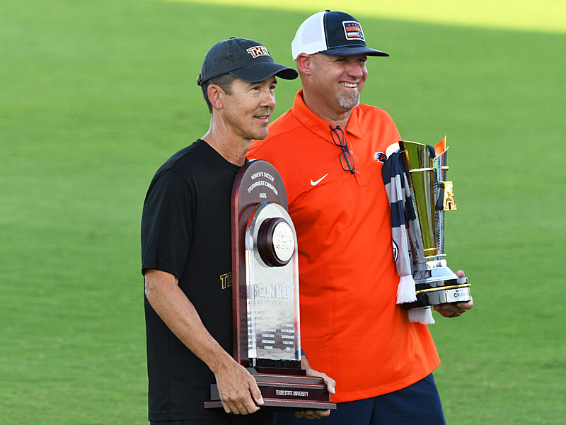 Texas State's Steve Holeman (left) and UTSA's Derek Pittman meet on the field with last season's championship trophies before Wednesday's season opener at Park West. - photo by Joe Alexander